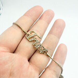 Gold-Tone “Trust” Adjustable Bracelet with Rhinestone Accents and Heart Charm